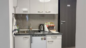 A compact kitchenette with a sink, a kettle, a coffee maker, and a dish rack. - Stunning home in Salopeki Modruski with WiFi (Salopeki Modruski)