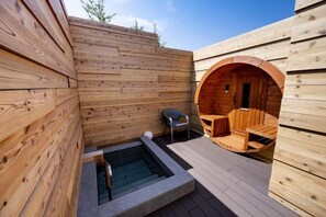 A wooden spa area with a hot tub, seating, and a sauna. - Inn the Fuji (Fujiyoshida)