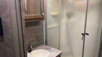Shower, hair dryer, towels, toilet paper