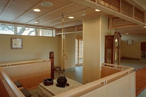 Une pièce de style japonais traditionnel, avec un sol recouvert de tatamis, un paravent shoji et un espace aménagé pour la cérémonie du thé.