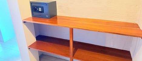 A wooden shelf unit with a small electronic device on top.
