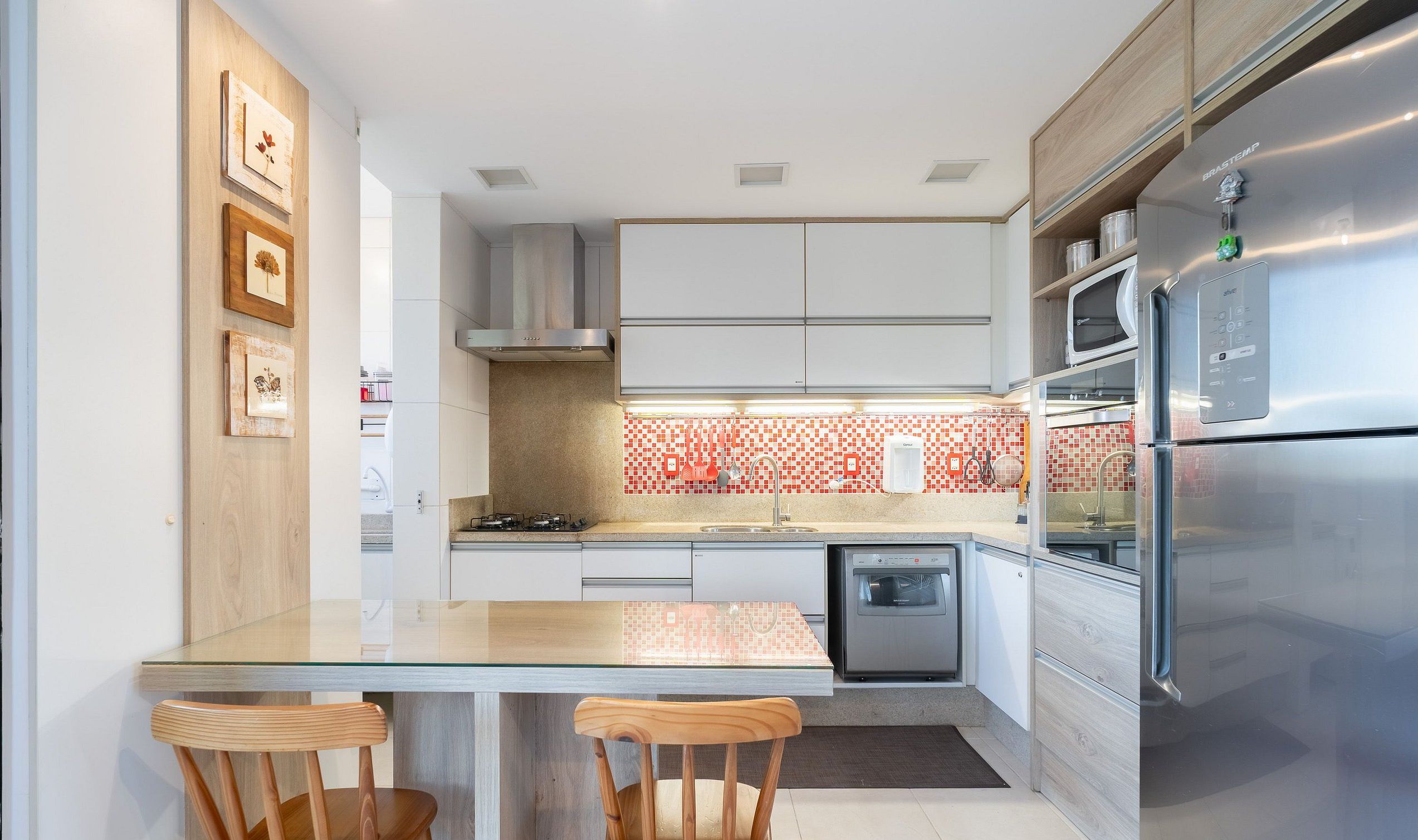 A modern kitchen with white cabinets, a stainless steel refrigerator, and a tiled backsplash.