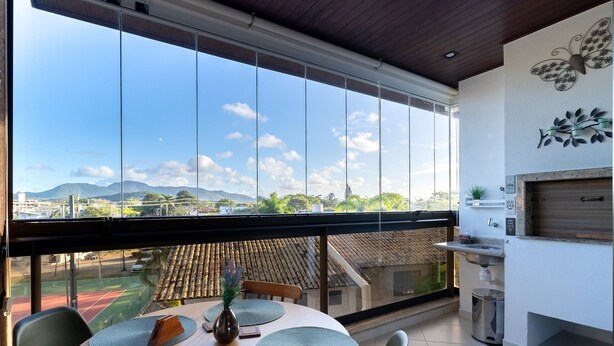 A dining area with a view of mountains and a sports field.