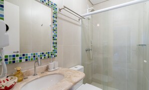 A bathroom with a glass shower enclosure, a sink with a marble countertop, and a mirror with a mosaic border. - Apt w/ Gourmet Balcony 300m From Beach Cms0202 (Florianópolis)