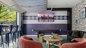 A modern room with a cityscape painting, a pool table, and comfortable seating. - Stable #6 ~ Fire Pits, Mini Golf, Games, Walkable (Louisville)