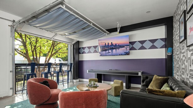 A modern living room with a pool table, a sofa, and a dining area with chairs. - Stable #6 ~ Fire Pits, Mini Golf, Games, Walkable (Louisville)