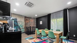 A modern kitchen with a black countertop, a coffee machine, and a sink. - Stable #6 ~ Fire Pits, Mini Golf, Games, Walkable (Louisville)