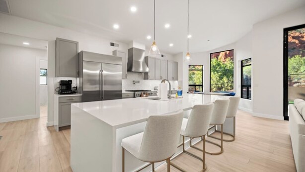 A modern kitchen with a large island, stainless steel appliances, and pendant lighting. - Luxe Chapel home Heated pool/Spa, & Red Rock views (Sedona)