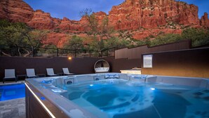 A hot tub with lounge chairs, a pool, and a mountainous backdrop. - Luxe Chapel home Heated pool/Spa, & Red Rock views (Sedona)