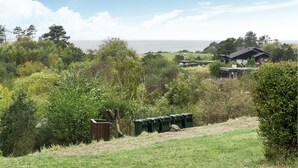 A residential area with houses surrounded by dense greenery and a view of the ocean. - Lovely home in Knebel with WiFi (Knebel)