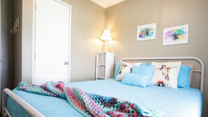 A bedroom with a bed, a nightstand, a lamp, and two wall art pieces. - 3 BEDROOM, 2 BATHROOM, POND, SLEEPS 6 (Rockport)
