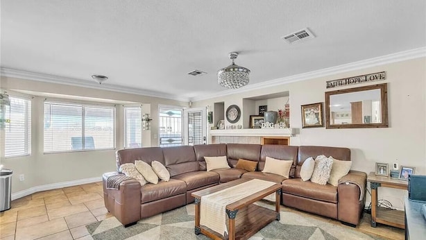 A living room with a brown leather sectional sofa, a wooden coffee table, and a chandelier. - 3-bedroom house in charming North Las Vegas with AC (North Las Vegas)