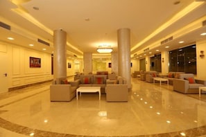 A spacious lobby with a central seating area, large pillars, and a polished floor. - Gloria Aqua Park (Aswan)