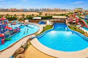 A water park with multiple pools and slides, surrounded by a desert landscape. - Gloria Aqua Park (Aswan)
