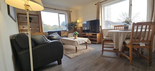 Deluxe Apartment, 2 Bedrooms, Private Bathroom, Courtyard View | Living area | 55-inch Smart TV with digital channels, Netflix, streaming services