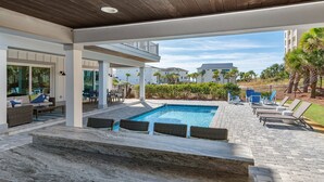 A pool area with lounge chairs and a stone ledge. - 6 Bedrooms | 6.5 Bathrooms | Sleeps 22 (Miramar Beach)