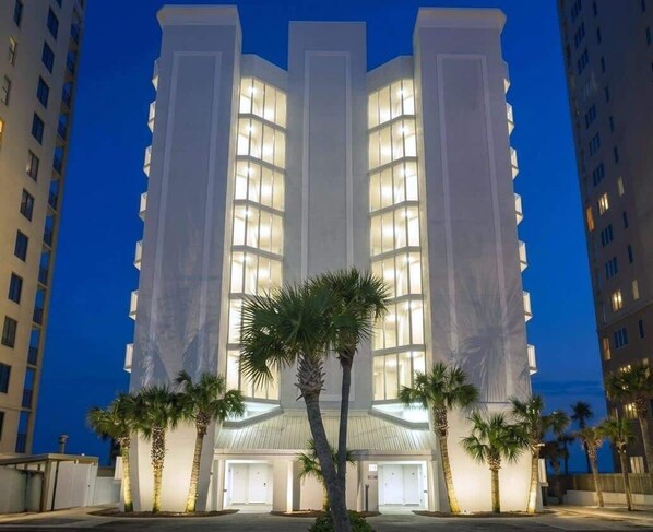 A high-rise hotel with a modern facade, multiple floors, and a central entrance.