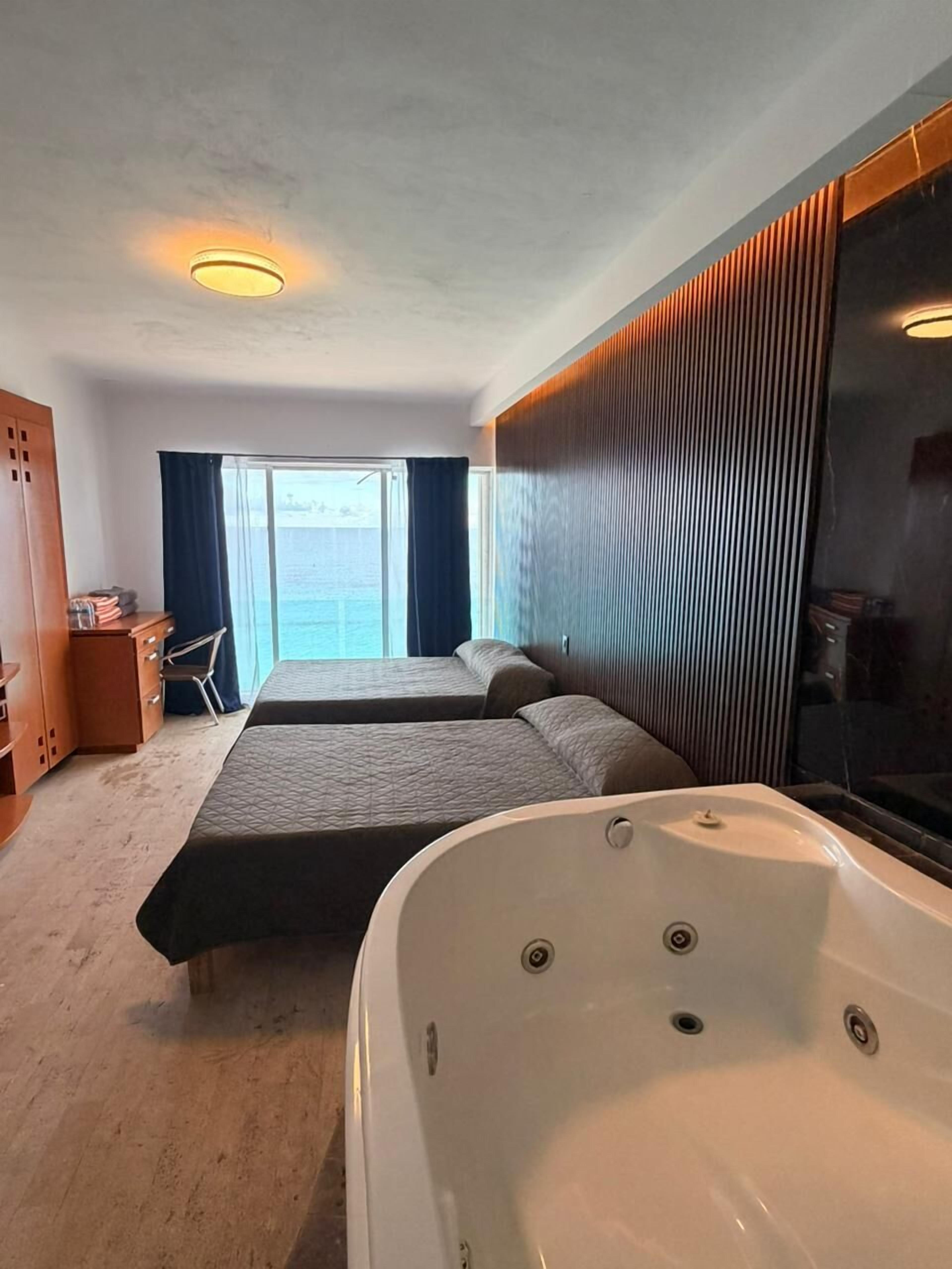 Superior Suite, Hot Tub, Sea View | In-room safe, blackout drapes, iron/ironing board, free WiFi