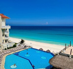 A hotel with a pool, beach, and ocean view. - Suites Luna y Sol Caribe (Cancún)