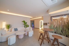 A modern living room with a sofa set, coffee tables, and a bar area. - poverta-stay hotel (Gyeongju)