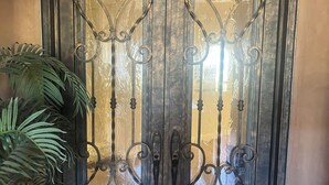 A double door with intricate metalwork and a keyhole. - Elegant Private 2-Bedroom Ensuite Condo with Expansive Living and Dining Areas (Rancho Mirage)