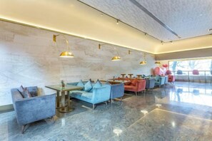 A modern interior with seating arrangements and pendant lighting. - Beijing Manxin Hotel Tiananmen Square (Beijing)