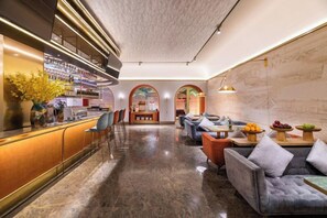 A hotel lobby with a bar area, seating, and a reception desk. - Beijing Manxin Hotel Tiananmen Square (Beijing)