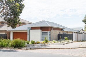 A modern two-story house with a garage, a fenced backyard, and a well-maintained garden. - The Lake House—Spacious Group Haven by the Bay (Victor Harbor)