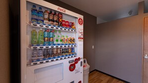 A vending machine with various beverages and snacks, including Coca-Cola and Fanta. - Hotel R9 The Yard Ube (Ube)