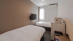 A hotel room with two single beds, a flat-screen TV mounted on the wall, a small refrigerator, and a microwave on a counter. - Hotel R9 The Yard Ube (Ube)