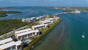 A coastal hotel with multiple buildings, a swimming pool, and a marina. - Sandpiper Key – Pool, Balcony & Beach Walks (Englewood)