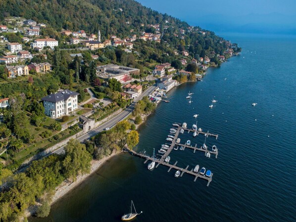 An aerial view of a coastal town with a marina, houses, and a prominent church.