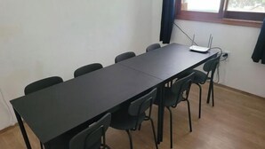 A conference room with a long table and six chairs. - Ocean's Guesthouse (Seoul)