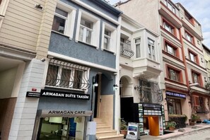 A building with a sign for 'ARMAGAN SUITE TAKSIM' and 'ARMAGAN CAFE' on the ground floor. - Armagan Suite Taksim (Istanbul)