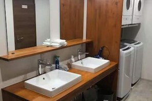 A bathroom with two sinks, a mirror, and a wooden vanity. - Guest House Siesta (Tokyo)
