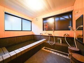 Separate bathtub and shower, towels, soap, shampoo