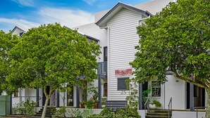 A modern two-story house with a white exterior, a visible number '25', and a small front porch with steps. - Comfy Studio Apartment in Marcoola Beach (Sunshine Coast)