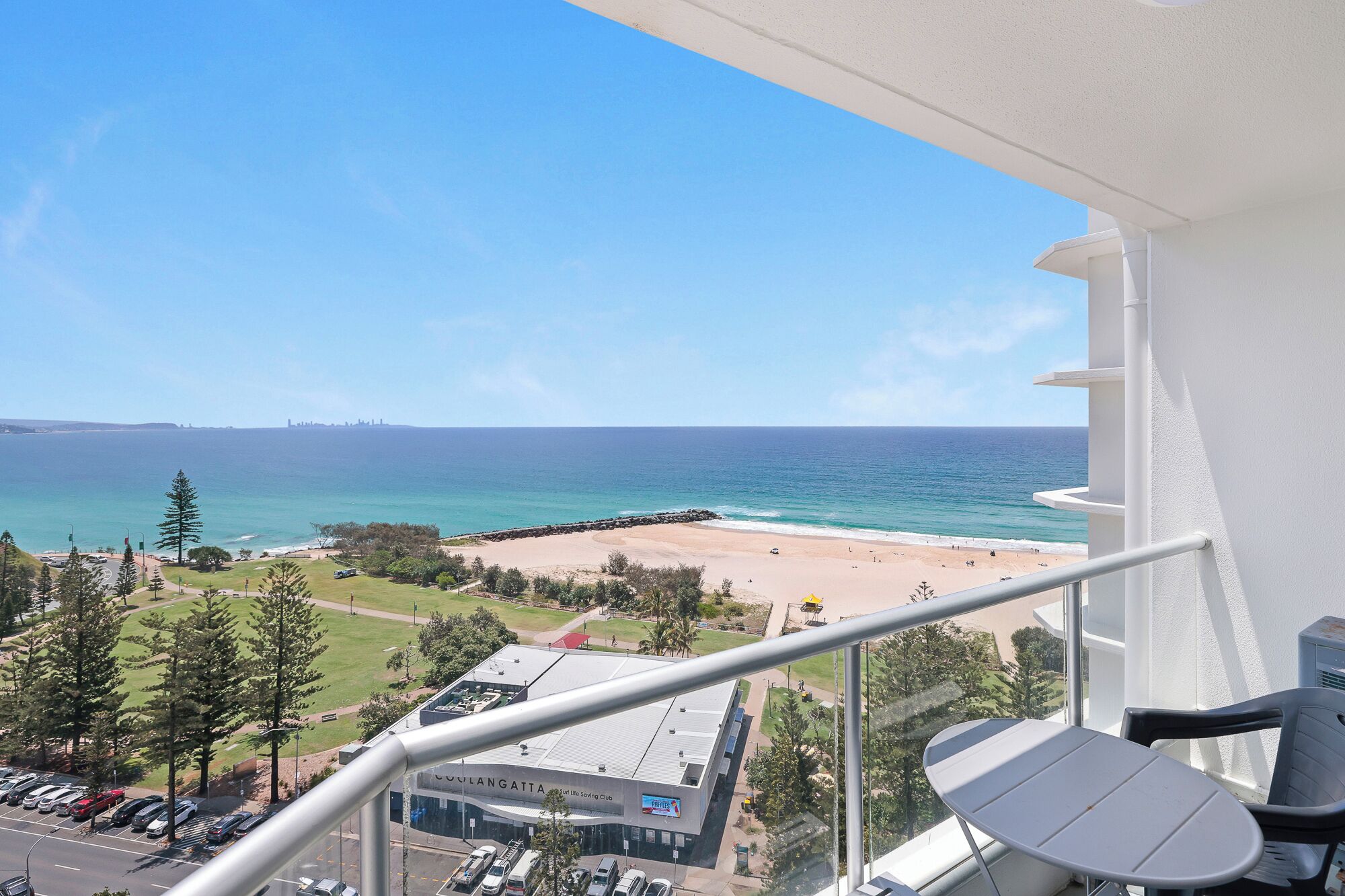 A balcony with a view of a beach and ocean.