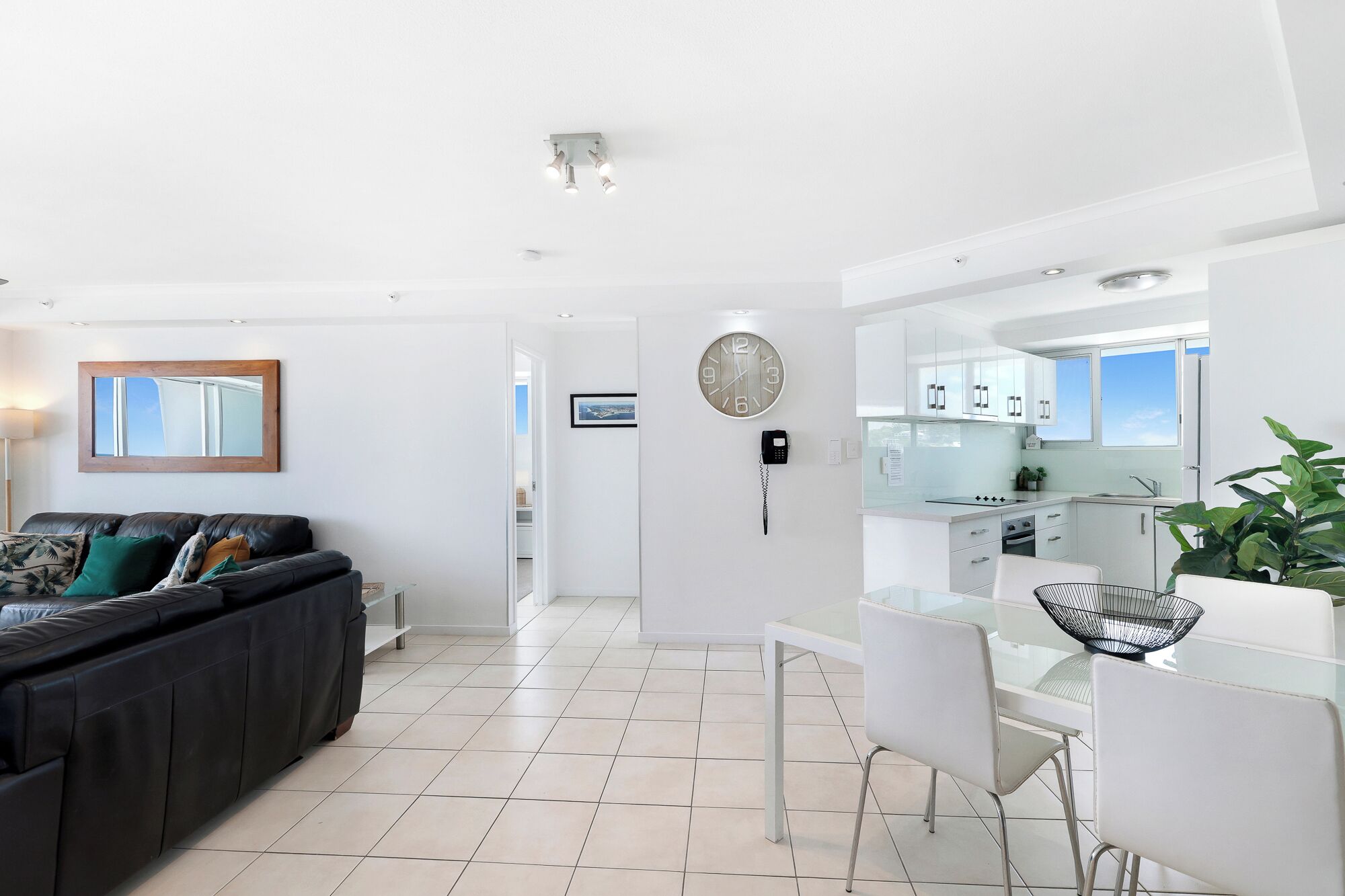 A modern apartment with a living area, kitchen, and dining space.