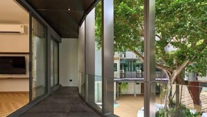 Un intérieur moderne avec un long couloir, de grandes fenêtres et une vue sur l’extérieur.