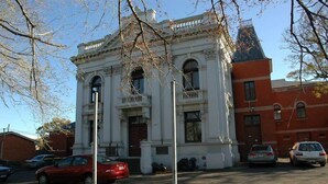 A historic building with a symmetrical facade, large windows, and a central entrance. - A Chic & Comfy 2BR Apt Near to Flemington Races (Melbourne)