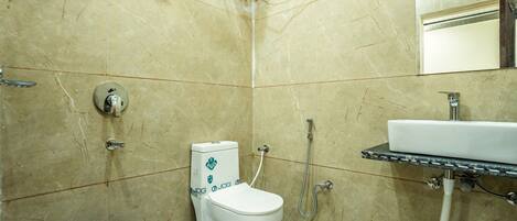 A bathroom with a toilet, a sink, and a shower.