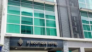 A hotel facade with large windows, a sign reading 'H Boutique Hotel,' and a visible entrance. - H Boutique Hotel Sri Petaling (Kuala Lumpur)