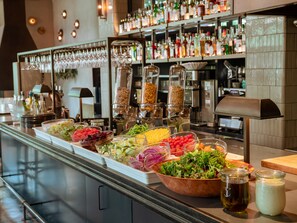 A buffet with various food items and a bar area with shelves of bottles. - THE KNOT UTSUNOMIYA (Utsunomiya)