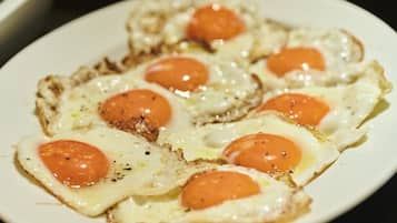 A plate of food with eggs and tomatoes on toast.