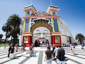 A large, colorful entrance with a prominent archway and a face design.