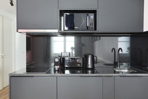 Fridge, microwave, stovetop, coffee/tea maker