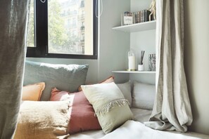 Desk, iron/ironing board, bed sheets