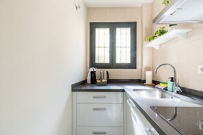 Fridge, microwave, stovetop, coffee/tea maker