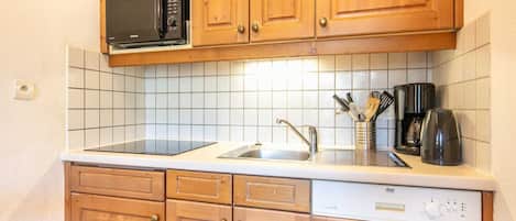 Een koelkast, een magnetron, een kookplaat, een vaatwasser